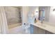 Elegant bathroom featuring marble tile, a shower-tub combo, and modern vanity at 523 S West St # 409, Raleigh, NC 27601