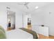 Bright bedroom featuring hardwood floors, a ceiling fan, and view to kitchen at 523 S West St # 409, Raleigh, NC 27601