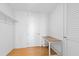 This bedroom features light hardwood floors, a wooden work desk, and a closet for storage at 523 S West St # 409, Raleigh, NC 27601