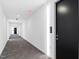 Long condo hallway with carpet and multiple doors; unit number shown by doorway at 523 S West St # 409, Raleigh, NC 27601
