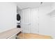 This laundry closet features a stacked washer and dryer with a work desk at 523 S West St # 409, Raleigh, NC 27601