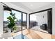 Bright living room featuring a balcony with city views and hardwood floors at 523 S West St # 409, Raleigh, NC 27601