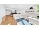 Bright living room featuring hardwood floors, a comfortable couch, and open kitchen and dining area at 523 S West St # 409, Raleigh, NC 27601