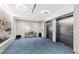 Lobby with elevators and table with lamp and chairs near textured wall at 523 S West St # 409, Raleigh, NC 27601