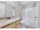 Bathroom with neutral-tone vanity with white countertops and combination tub and shower at 5904 Eaglesfield Dr, Raleigh, NC 27613