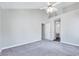 Inviting bedroom features a ceiling fan, neutral walls, plush carpet, and ensuite bathroom at 5904 Eaglesfield Dr, Raleigh, NC 27613