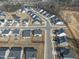 An aerial view of a neighborhood featuring single Gathering homes, tree lined streets, and a community pond at 652 Marion Hills Way, Knightdale, NC 27545
