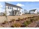 A view of the backyard showing the patio with screen, landscaped plantings, and fence at 652 Marion Hills Way, Knightdale, NC 27545