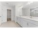 Bathroom showcases double sinks with white cabinetry and quartz countertops at 652 Marion Hills Way, Knightdale, NC 27545