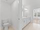 Bright bathroom featuring double vanity with white cabinets, tile flooring, and a separate toilet area at 652 Marion Hills Way, Knightdale, NC 27545