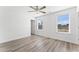 Bright bedroom featuring a ceiling fan, two windows, and neutral color palette at 652 Marion Hills Way, Knightdale, NC 27545