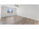 A bright bedroom with a ceiling fan, and hardwood floors, with natural light from the large window at 652 Marion Hills Way, Knightdale, NC 27545
