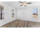 Bright bedroom with wood-look floors, white walls, a ceiling fan, and large windows for ample light at 652 Marion Hills Way, Knightdale, NC 27545