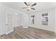 Spacious bedroom with wood floors, a ceiling fan, large windows, and glass panel doors for an open feel at 652 Marion Hills Way, Knightdale, NC 27545