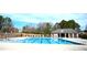 View of the community pool with a fenced perimeter and community house at 652 Marion Hills Way, Knightdale, NC 27545