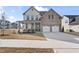 Charming two-story home with a brick and siding exterior, a two-car garage, and a welcoming front porch at 652 Marion Hills Way, Knightdale, NC 27545