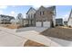 A front exterior view of this 2-car garage home featuring a covered porch and large driveway at 652 Marion Hills Way, Knightdale, NC 27545