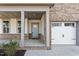 Close-up of a home's inviting front porch with stylish columns and a light blue front door at 652 Marion Hills Way, Knightdale, NC 27545