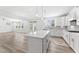 A large kitchen island with white cabinets and quartz countertops offering ample prep space at 652 Marion Hills Way, Knightdale, NC 27545