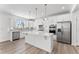 Modern kitchen boasts stainless appliances, white cabinets, and a large central island at 652 Marion Hills Way, Knightdale, NC 27545