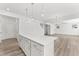 Kitchen island featuring white cabinets, quartz countertops, and modern hardware at 652 Marion Hills Way, Knightdale, NC 27545