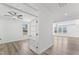 Inviting living room featuring hardwood floors, a ceiling fan, and plenty of natural light from large windows at 652 Marion Hills Way, Knightdale, NC 27545