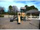 View of the community playground with a slide and swing set at 652 Marion Hills Way, Knightdale, NC 27545