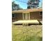 New wooden backyard deck, perfect for outdoor entertainment, with a brick house and green grass at 722 Forge Rd, Durham, NC 27713
