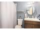 Bathroom with a shower curtain, sink, and mirror, providing essential amenities at 722 Forge Rd, Durham, NC 27713