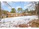 Exterior shot of a single-story brick home featuring a deck and snow covered yard at 722 Forge Rd, Durham, NC 27713