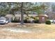 Charming single-story home featuring a brick facade and a well-maintained front yard with mature trees at 722 Forge Rd, Durham, NC 27713