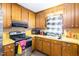 Functional kitchen with wooden cabinets, laminate countertops, and modern appliances at 722 Forge Rd, Durham, NC 27713