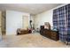 Spacious room with carpet, a door, and a window at 722 Forge Rd, Durham, NC 27713