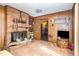Living room features a brick fireplace, wood paneled walls, and a view of other rooms at 722 Forge Rd, Durham, NC 27713