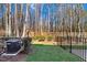 Spacious backyard featuring well-maintained lawn, wooden fence, and privacy trees at 736 Wickham Ridge Rd, Apex, NC 27539