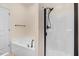 Modern bath with black fixtures and a tub/shower with white tile at 736 Wickham Ridge Rd, Apex, NC 27539