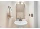 Bathroom featuring pedestal sink, designer mirror, and modern fixtures at 736 Wickham Ridge Rd, Apex, NC 27539
