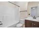 Bright bathroom featuring a shower tub combo and wood cabinets at 736 Wickham Ridge Rd, Apex, NC 27539