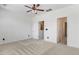 Bedroom with neutral carpet, white walls and ceiling fan plus two doorways at 736 Wickham Ridge Rd, Apex, NC 27539