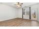 Bright bedroom features wood-look floors, a window, and a glass door at 736 Wickham Ridge Rd, Apex, NC 27539