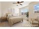 Staged bedroom with neutral tones, a large window, and modern decor at 736 Wickham Ridge Rd, Apex, NC 27539