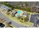 Aerial view of the community pool, playground, and amenities for recreation and relaxation at 736 Wickham Ridge Rd, Apex, NC 27539