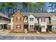 View of the exterior of townhomes with brick and siding accents at 736 Wickham Ridge Rd, Apex, NC 27539