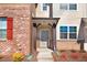 Close-up of a townhome entrance with red brick, neutral siding, and a covered porch with address plaque at 736 Wickham Ridge Rd, Apex, NC 27539
