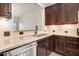 Modern kitchen featuring granite counters, stainless steel dishwasher, and dark wood cabinets at 736 Wickham Ridge Rd, Apex, NC 27539