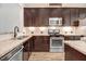 Modern kitchen featuring stainless steel appliances, granite counters, and ample cabinet space at 736 Wickham Ridge Rd, Apex, NC 27539