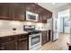 Updated kitchen with stainless steel appliances, gas range, and stylish dark wood cabinetry at 736 Wickham Ridge Rd, Apex, NC 27539
