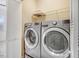 Convenient laundry room featuring a modern washer and dryer set and shutter doors to a utility closet at 736 Wickham Ridge Rd, Apex, NC 27539