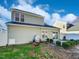 The backyard is surrounded by green shrubs and a white fence at 8209 Rolling Glenn Dr, Raleigh, NC 27616