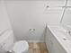 Well-lit bathroom features a modern vanity and toilet at 8209 Rolling Glenn Dr, Raleigh, NC 27616